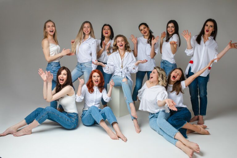 Women Solidarity Concept. Happy Young Female Team Stylish Staff Posing For Group Studio Photography, Girls Wearing Jeans